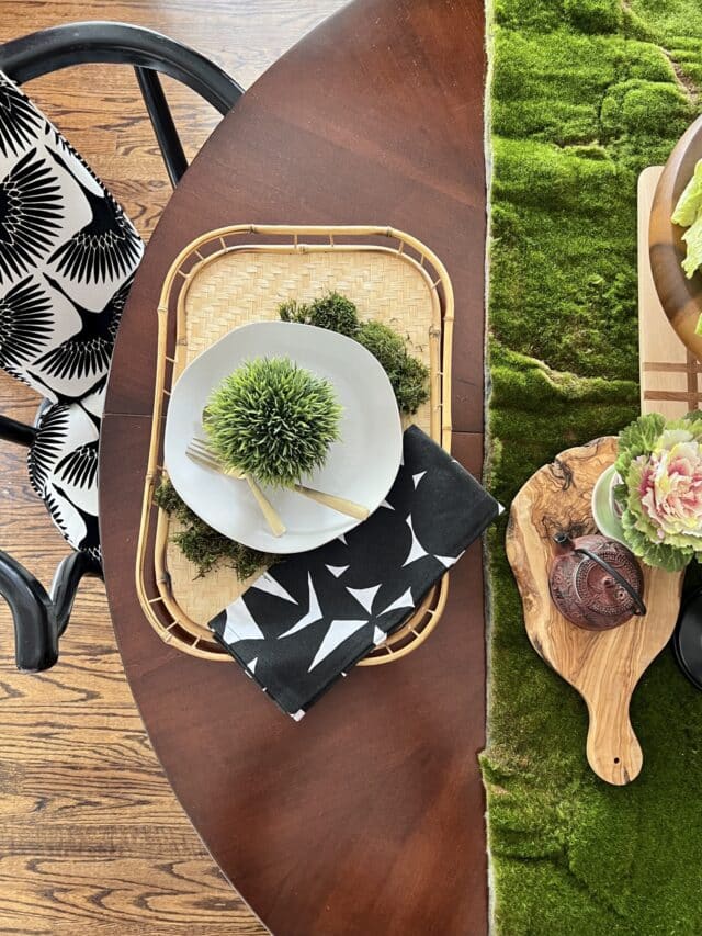 A green moss table runner on a wood dining table.