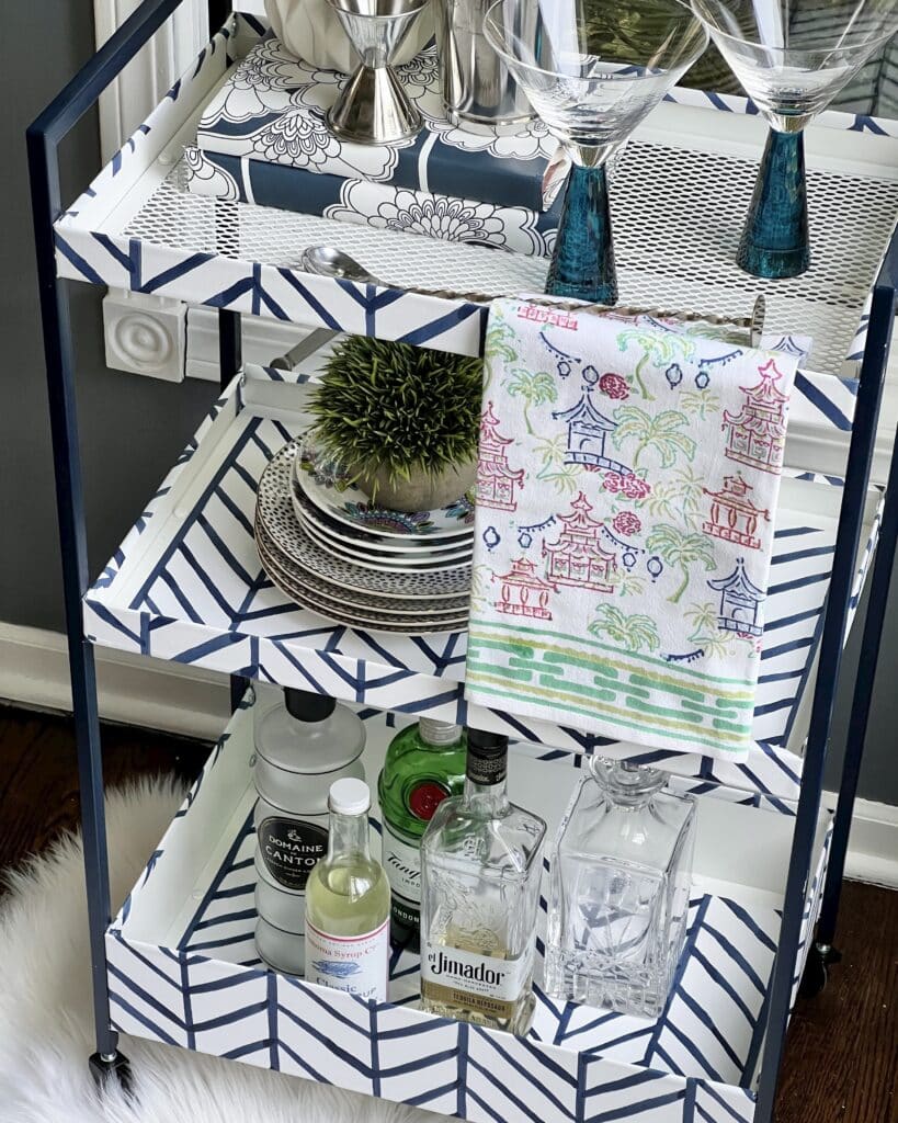 An ikea cart that got a makeover into a bar cart using wallpaper.