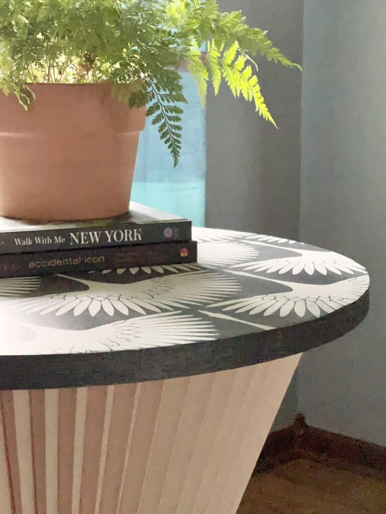 A diy accent table made from a fabric lampshade.