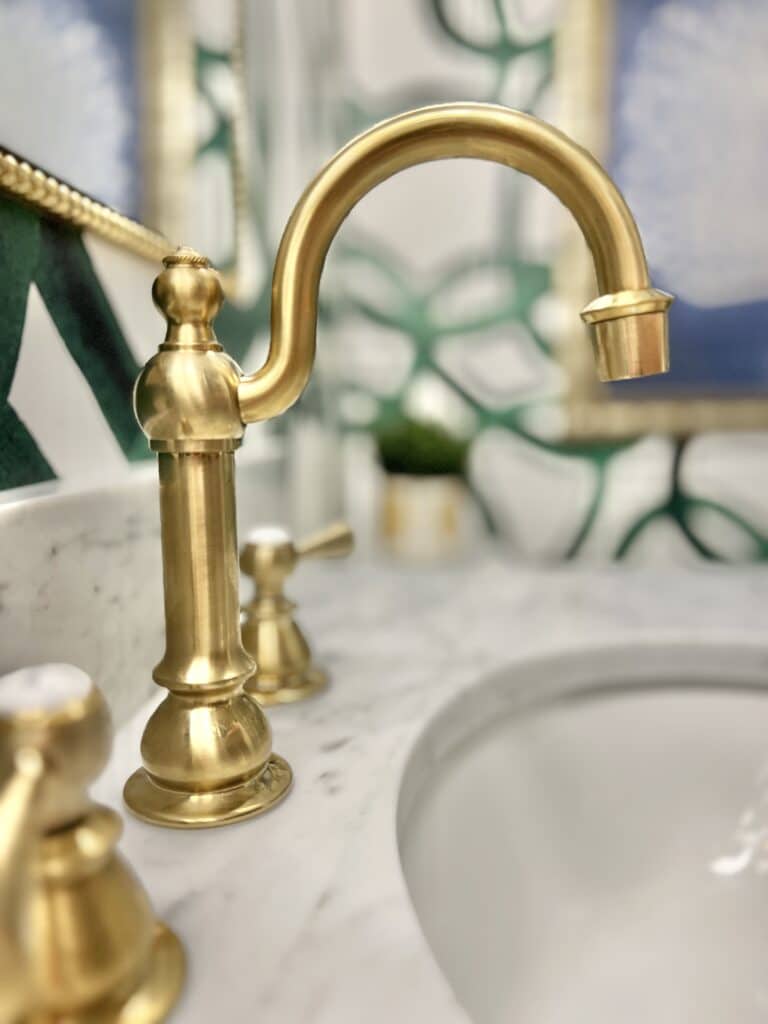 A curvy gold faucet in the Sonata Home Design ORC Powder room makeover.