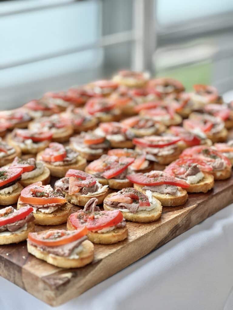 Bruschetta on a wood charcuterie board.