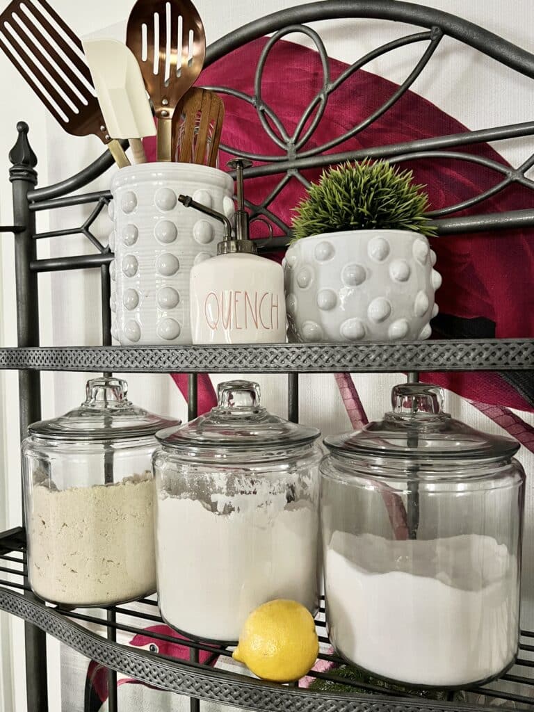 glass canisters on a bakers rack.