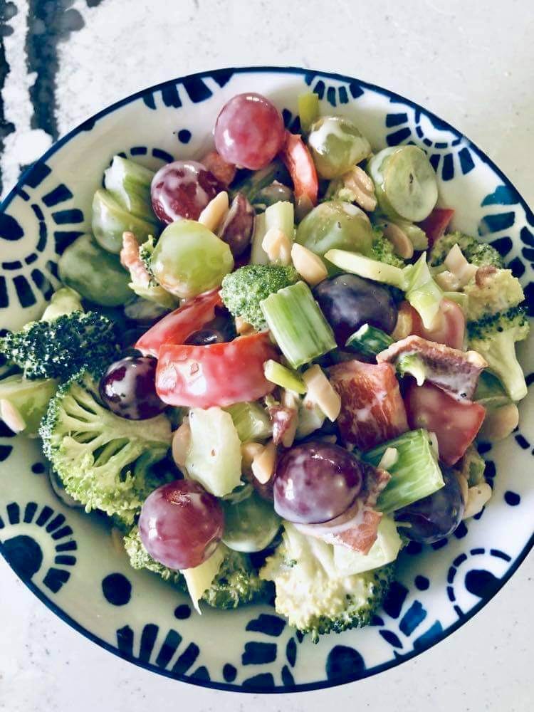 A dish full of broccoli grape salad.