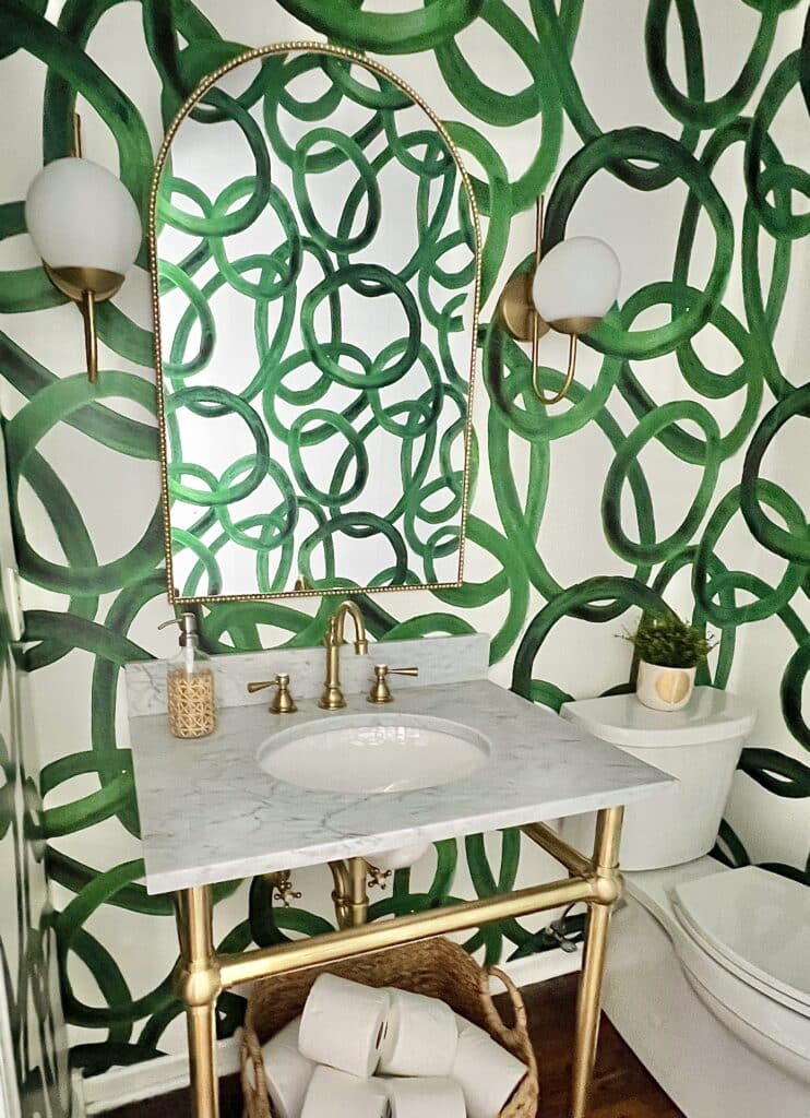 Half bath with bold green wallpaper.