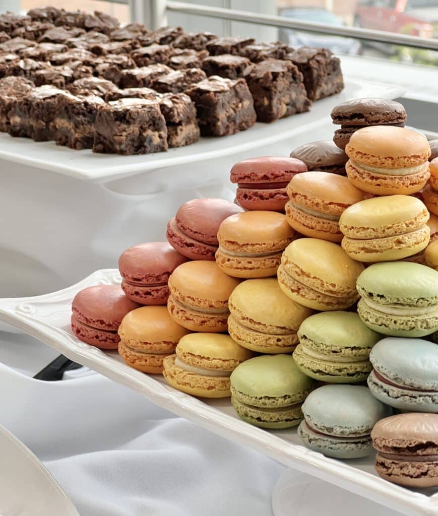 A tray of Symphony Brownie Bites and a stack of multi-colored macarons.