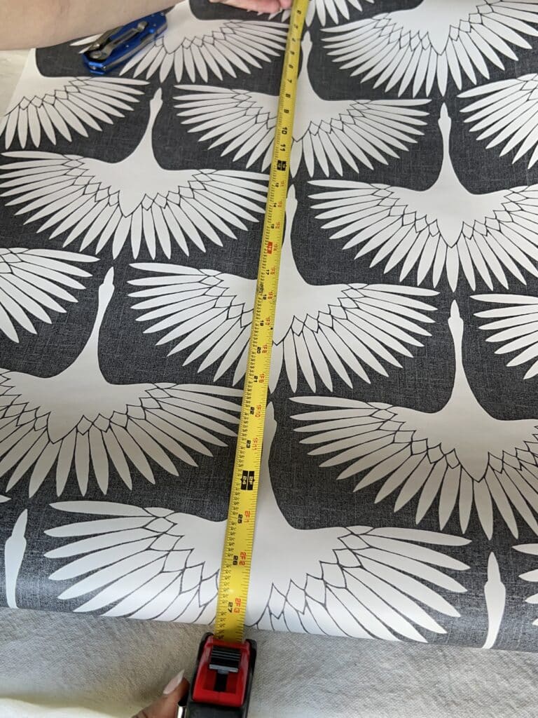 Measuring the peel and stick wallpaper for the diy fabric lampshade tabletop.