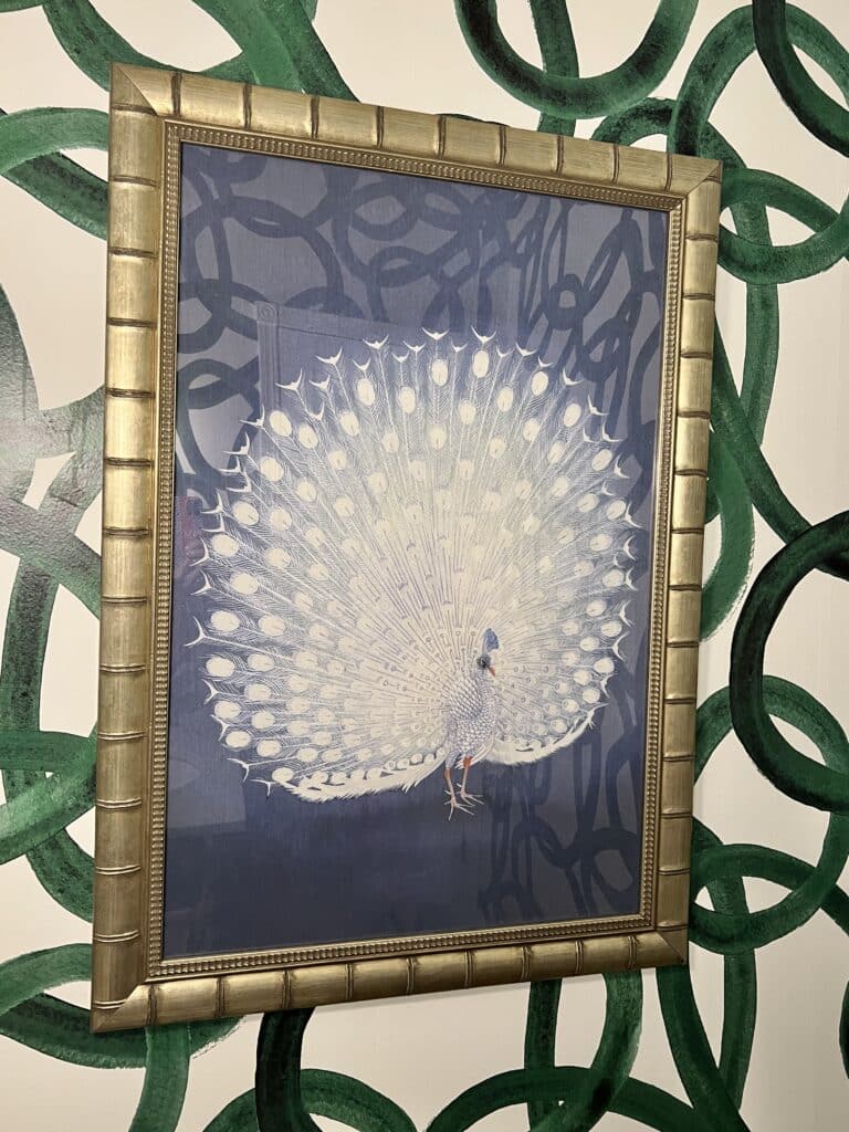 Peacock wall art from Urban Garden Design in gold frame.