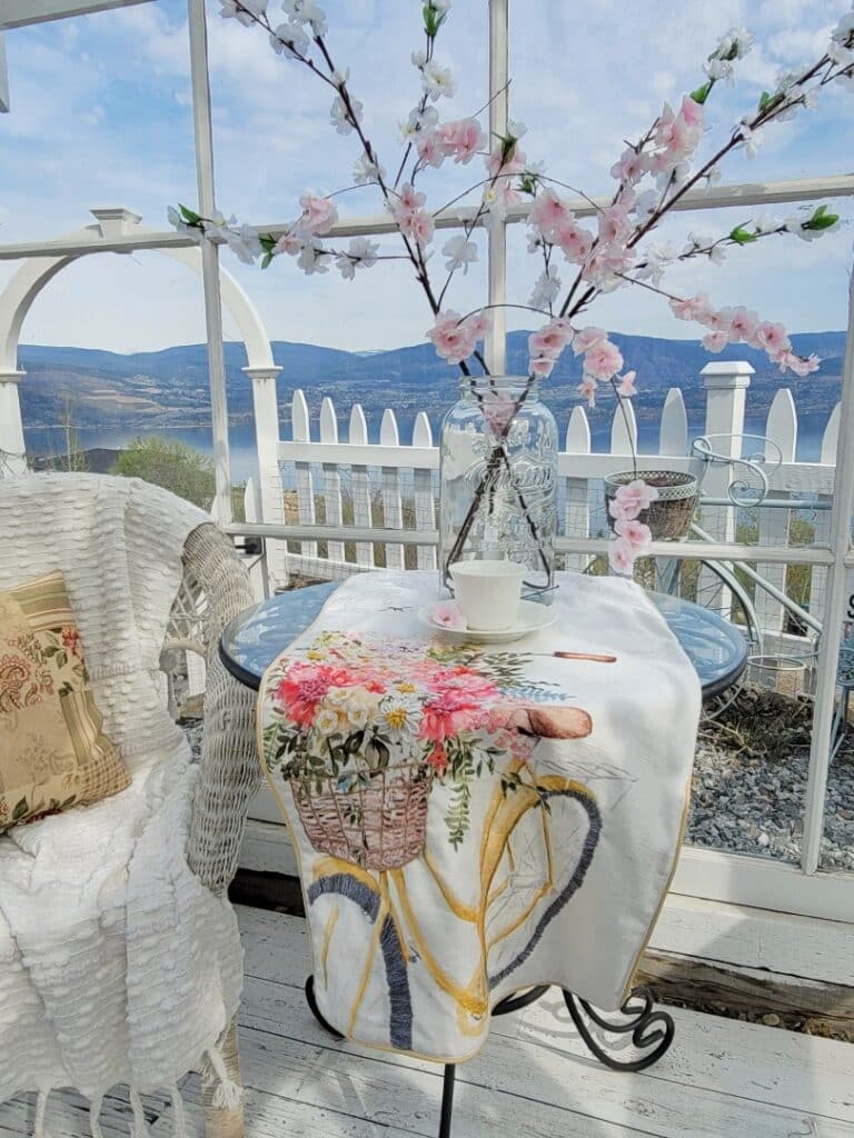 A table runner draped on an outdoor table. The table runner has an image of a bicycle on the front. Image by Sweet Valley Acres.