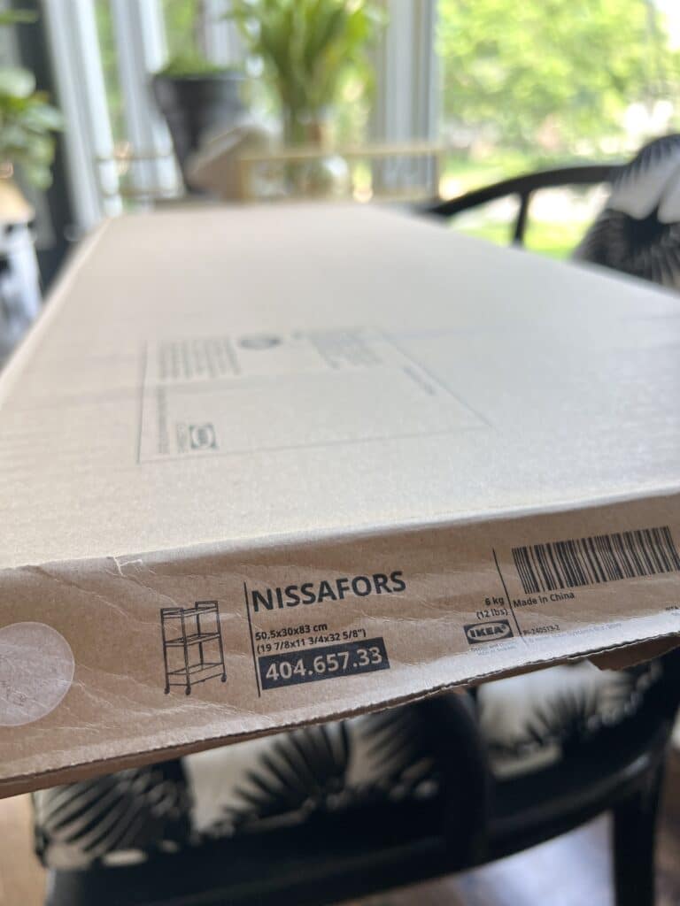 A shipping box from Ikea that holds the Nissafors cart.