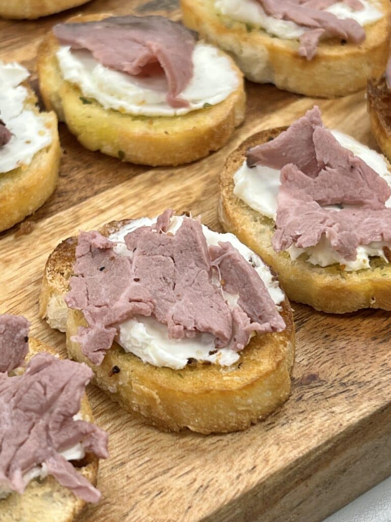 This recipe calls for thinly slice roast beef on top of the cream cheese for this baguette appetizer.