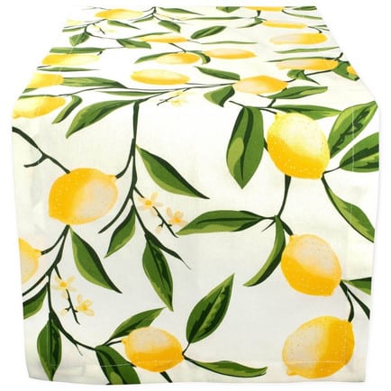 A table runner with images of lemons on the vine.