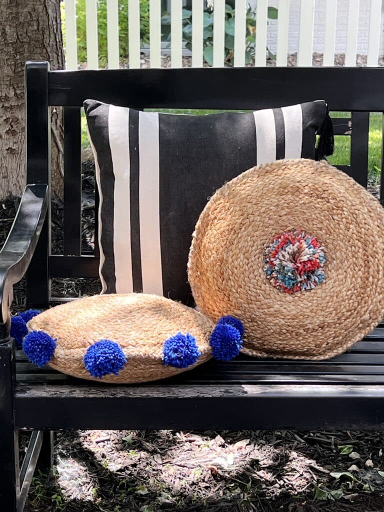 Two boho style pillows that were made with jute placemats and pom poms as a DIY project.