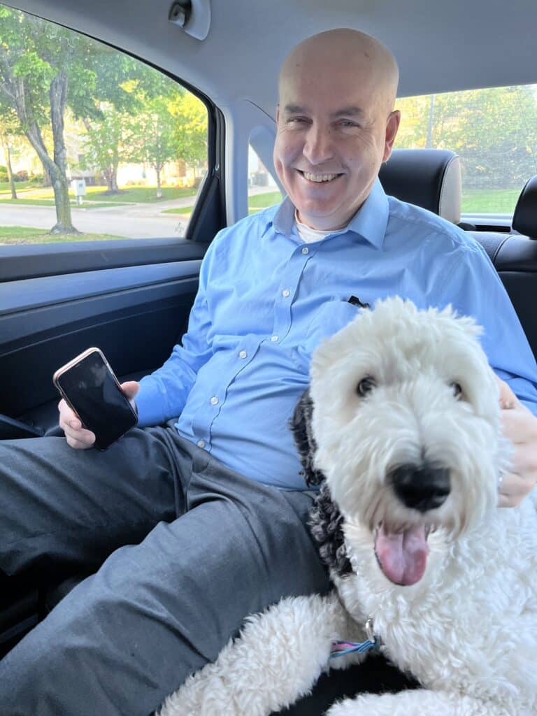 Brian and Bentley sitting in the backseat of the car.