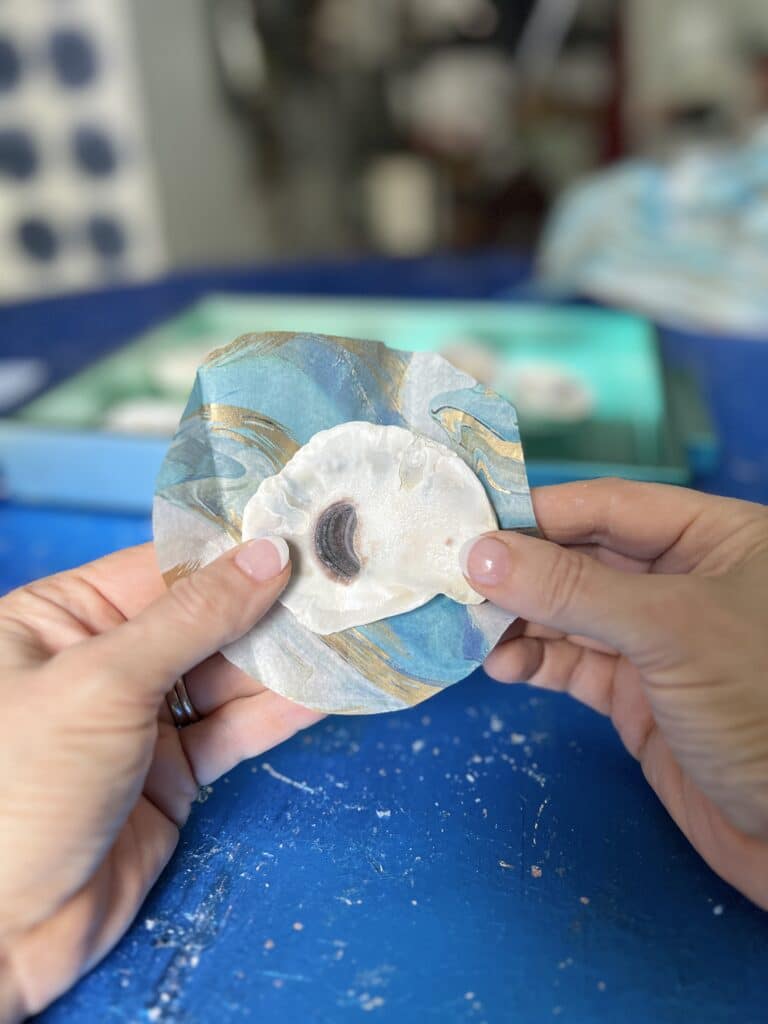 DIY oyster shell chandelier: Cutting tissue paper slightly larger than the oyster shell.