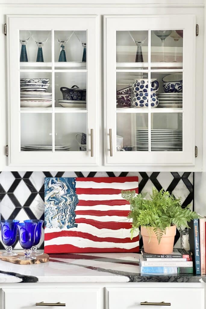 This flag DIY abstract wall art propped against the backsplash in the kitchen.