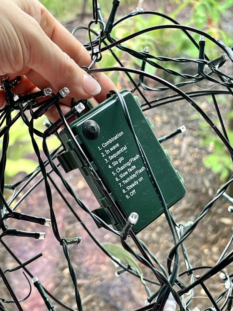 Attaching the battery pack of the fairy lights inside the globe.