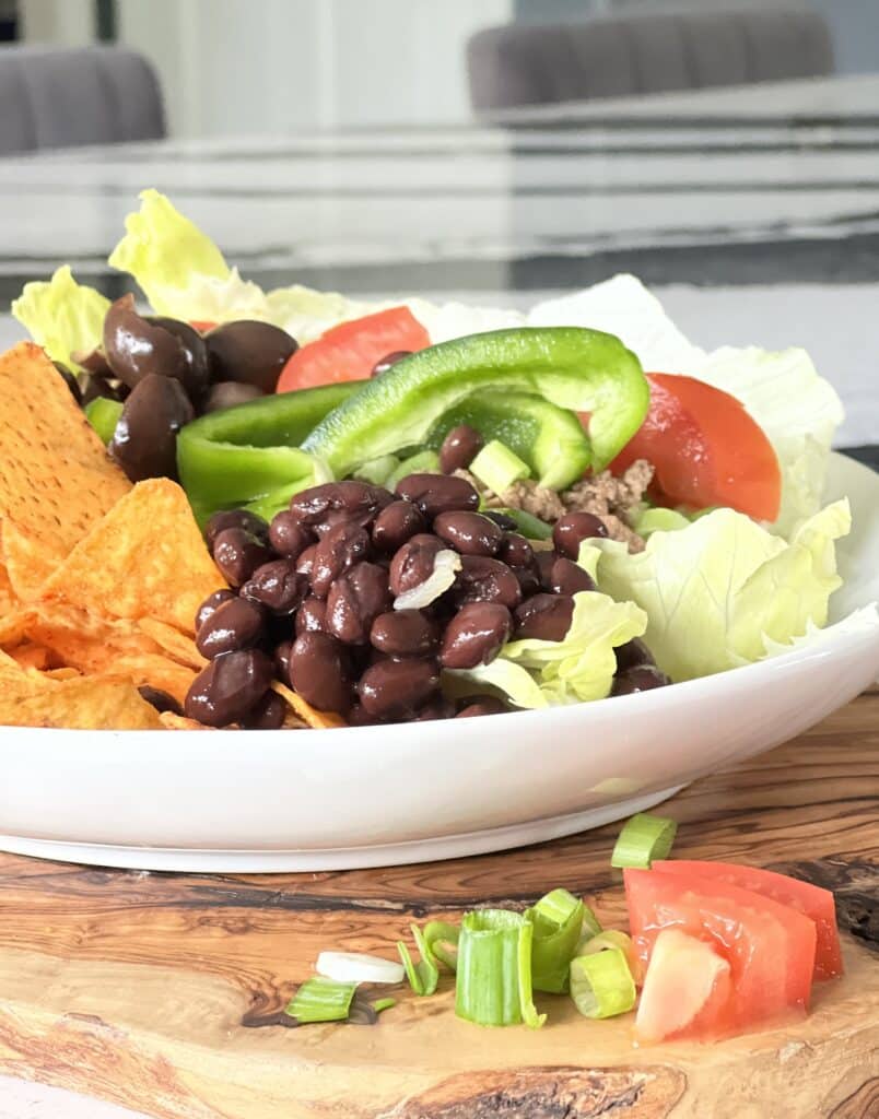 Healthy Mexican salad recipes sitting on a wood cutting board.