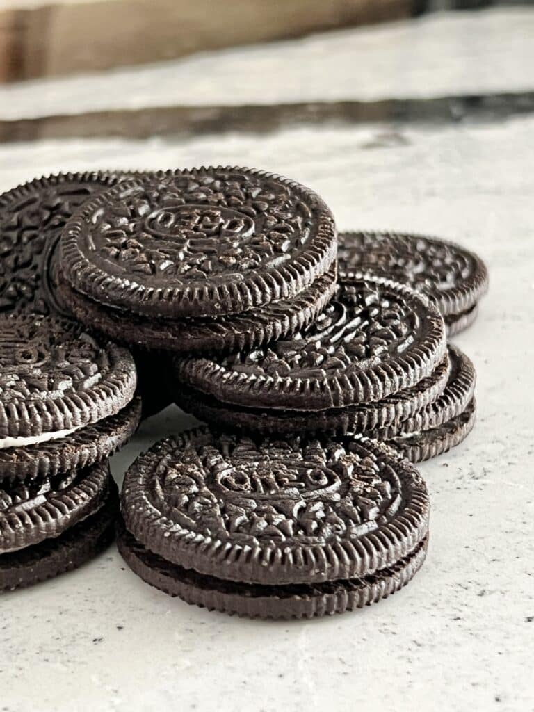 A pile of Oreo cookies on the counter top.