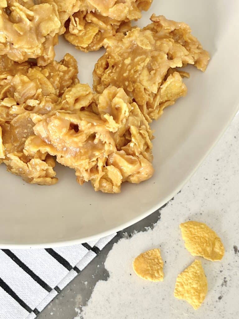 A white plate full of peanut butter corn flake cookies.