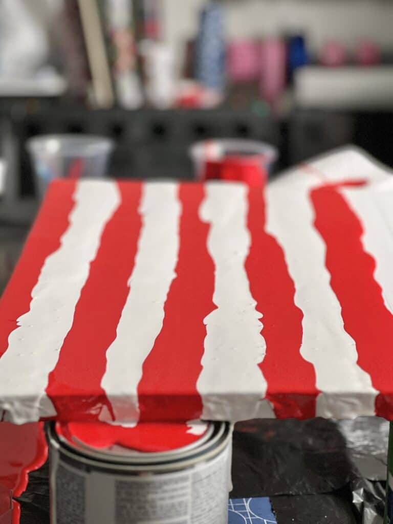 The completed red and white stripes on this DIY abstract canvas wall art.