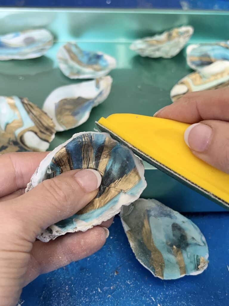 Sanding the edge of the oyster shell.