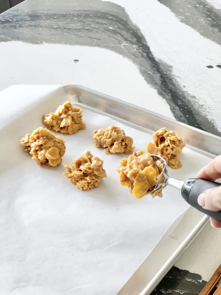 cereal cookie recipes: Scooping the peanut butter cereal mixture onto a baking sheet.