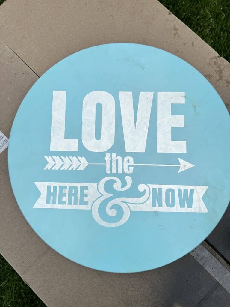 A thrifted Lazy Susan with a blue and white quote on the top.