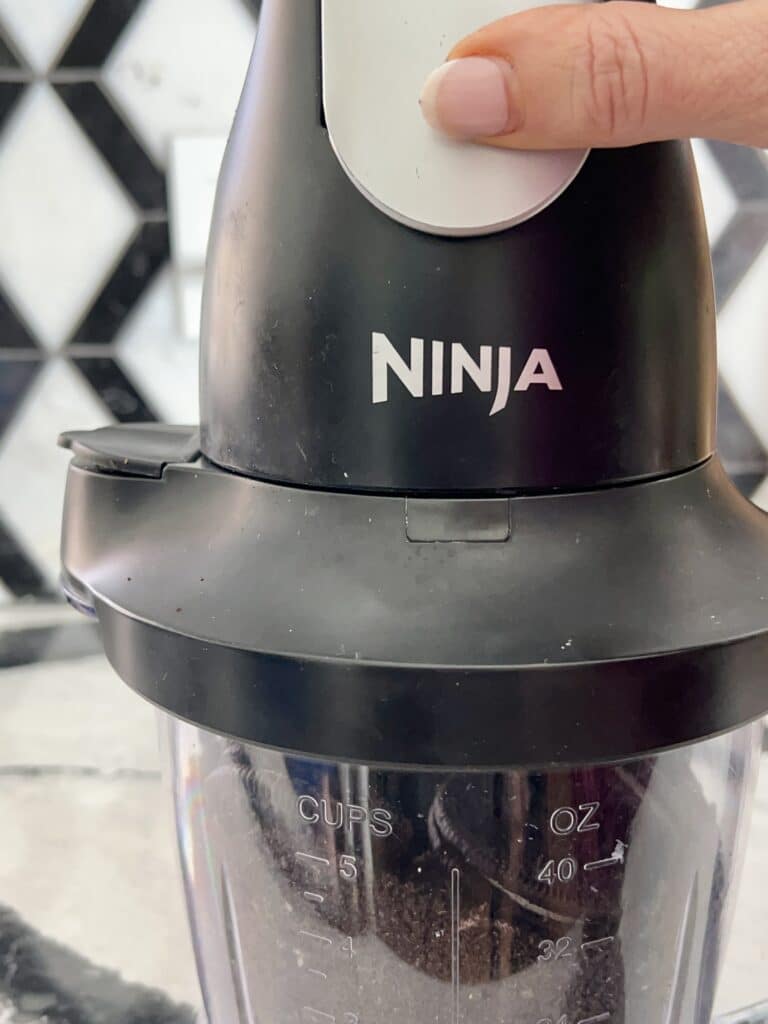 Using a Ninja food processor to crush the Oreo cookies.