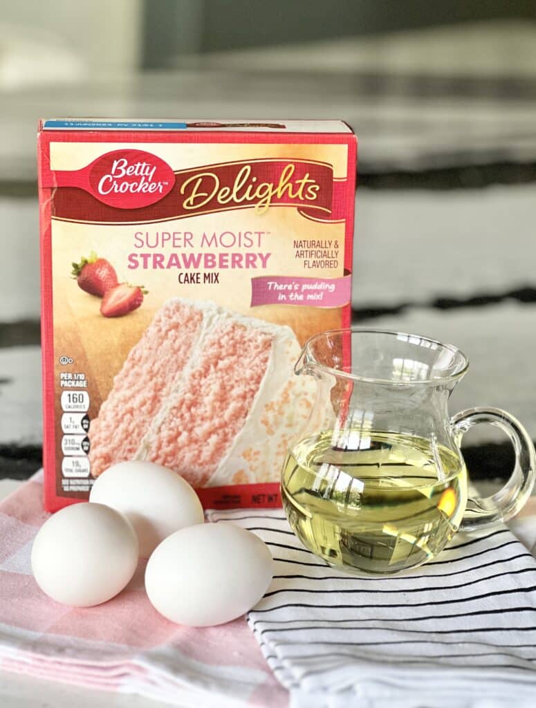 The three ingredients used in a strawberry cake cookie recipe.