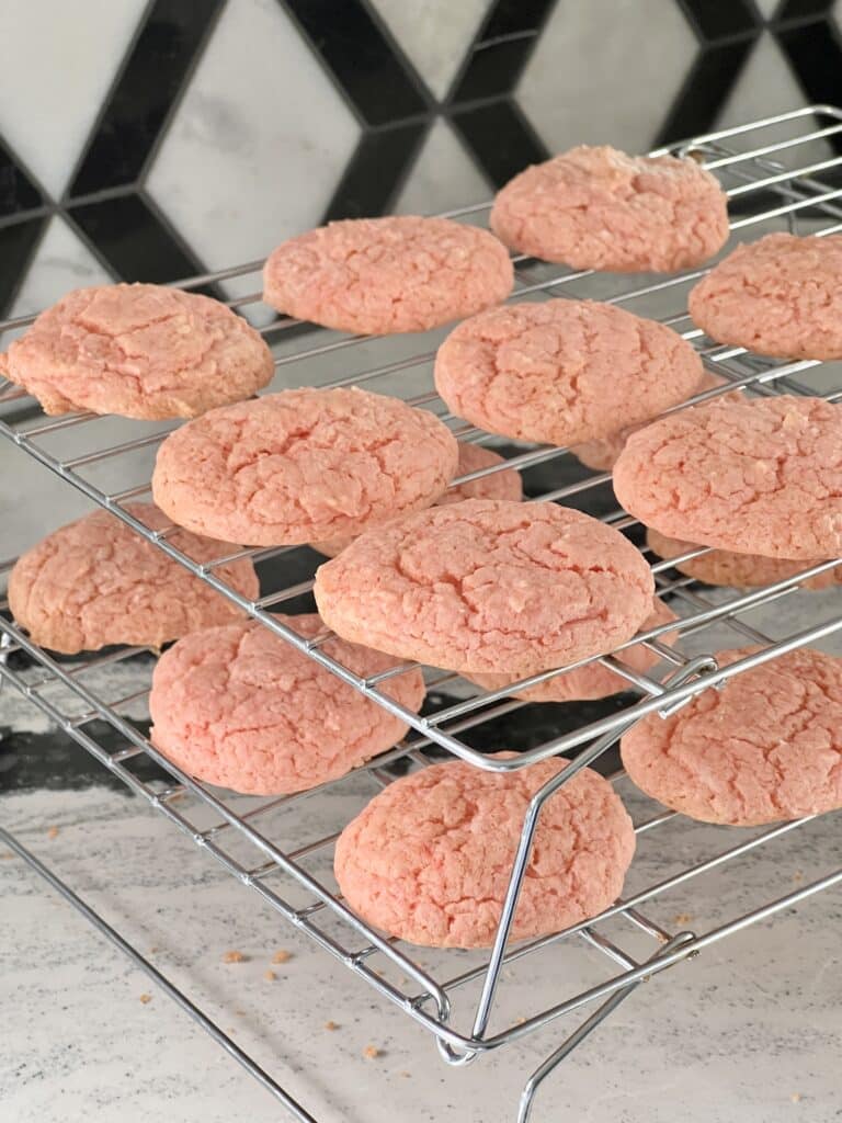 Cooling racks full of 3 ingredient pink strawberry cake cookies.