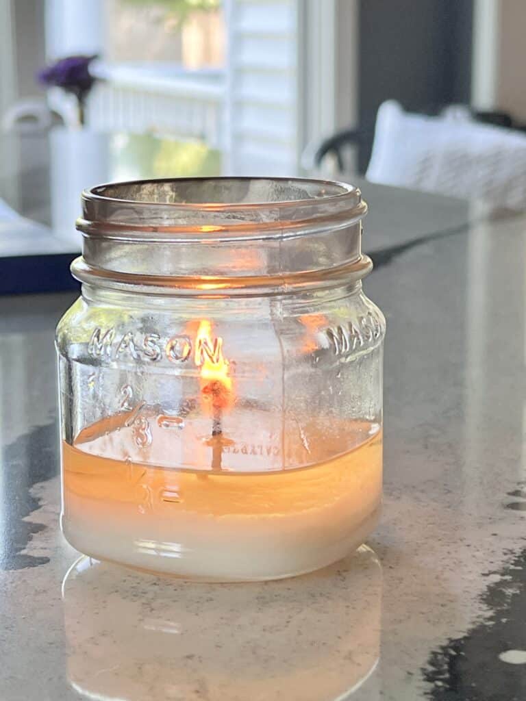 How to clean jar candles: A jar candle burning to the bottom of the container.