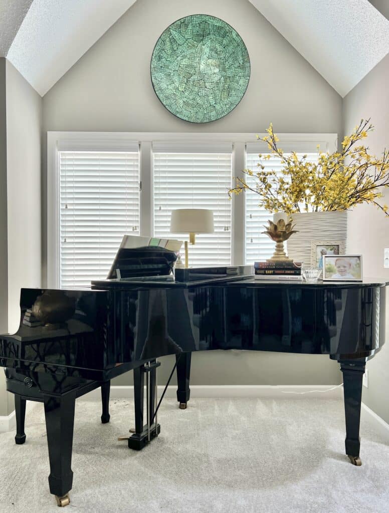 piano decorating ideas: a large piece of wall art hanging above a baby grand piano.