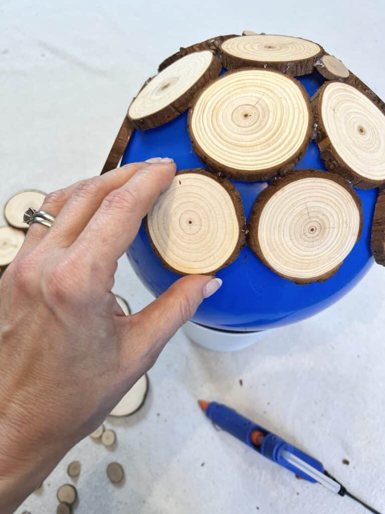 Using a balloon as a curved template for glued wood slices.