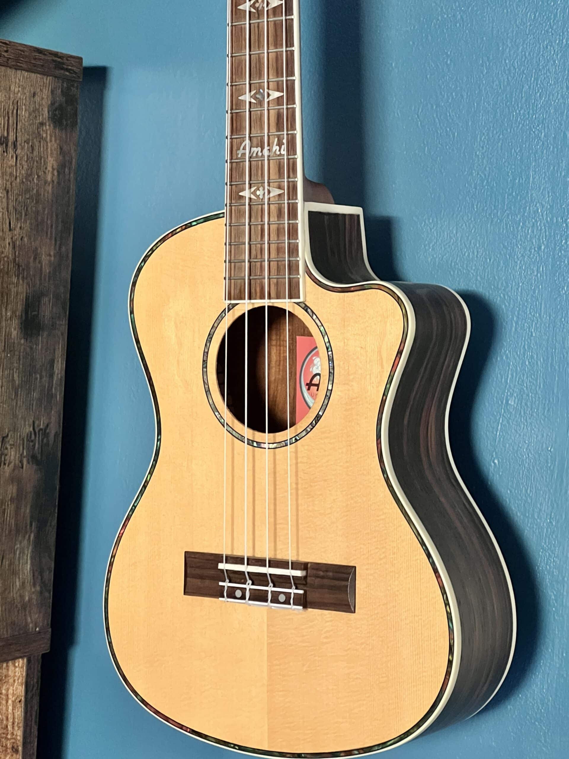 A guitar hanging on a wall.