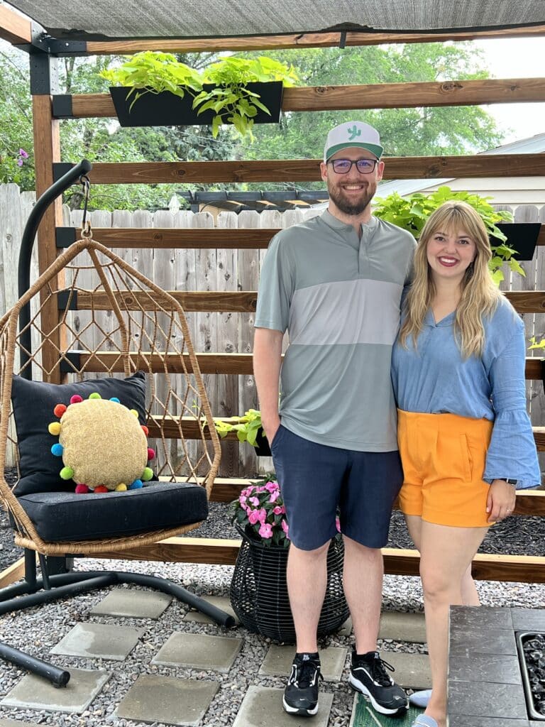 Madeline and Will standing under their new DIY Toja Grid pergola kit.