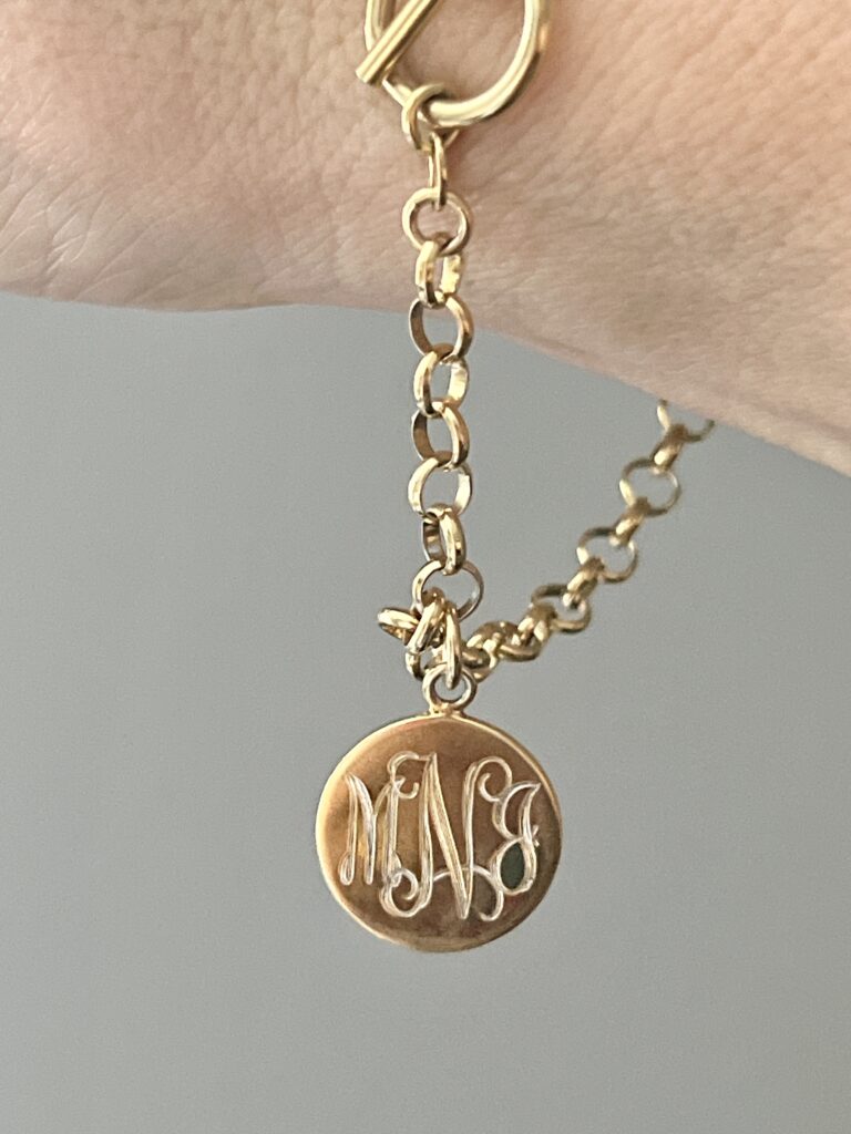 Ideas for How to Wear Monogrammed Clothing with Style: A gold monogram charm bracelet.