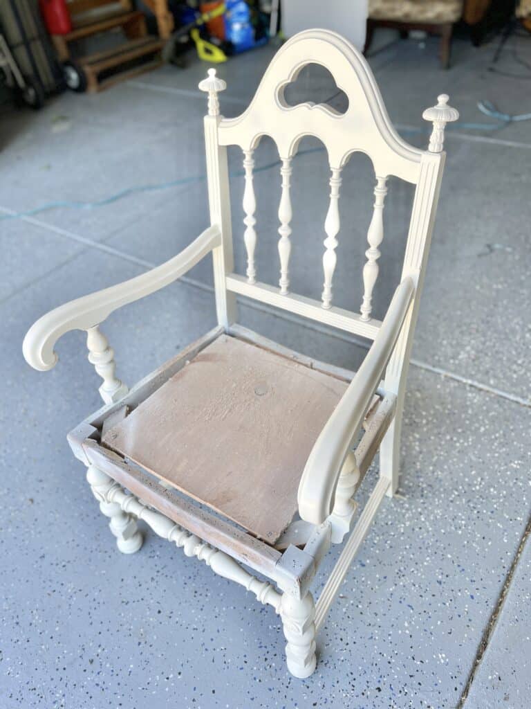 A chair frame that has been painted white.