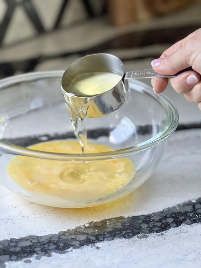 3 ingredient strawberry cake cookies: Pouring vegetable oil into a bowl.