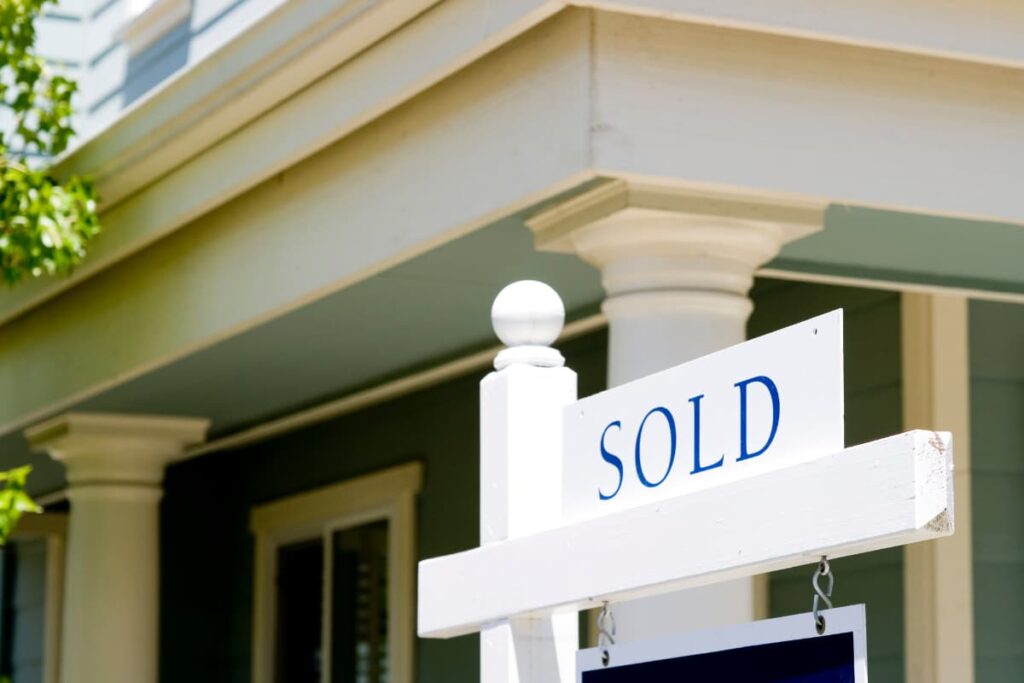 A sold sign in front of a house.