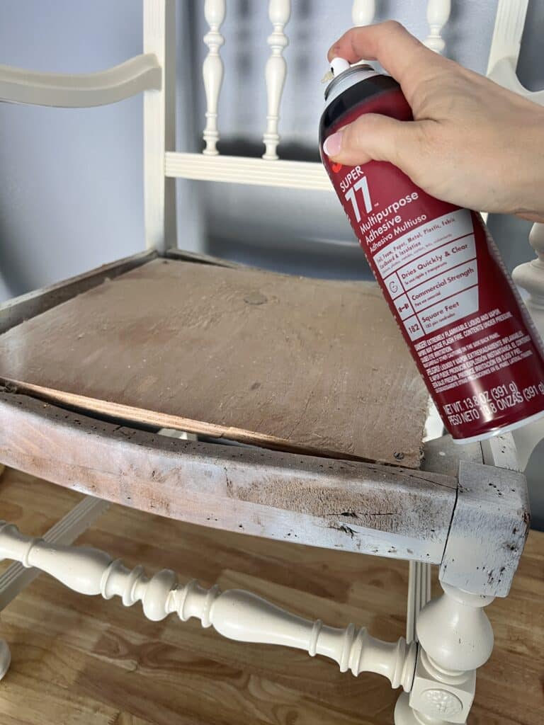 
Spraying adhesive onto the chair frame.