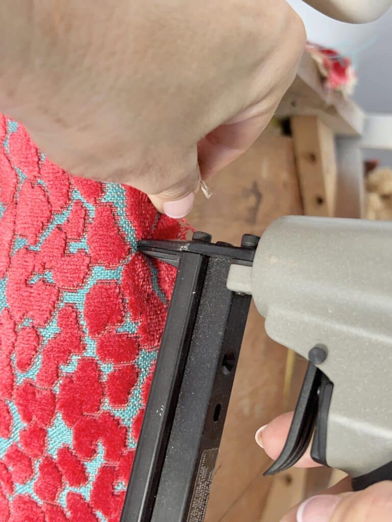 upholstery diy chair seat: stapling a fabric edge to a chair frame.