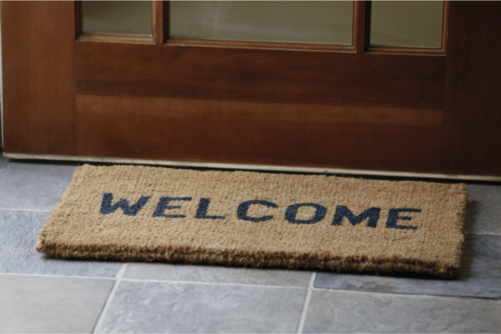 a welcome sign in front of a door.