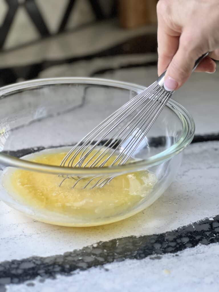 3 ingredient strawberry cake cookies: Whisking together eggs and vegetable oil.