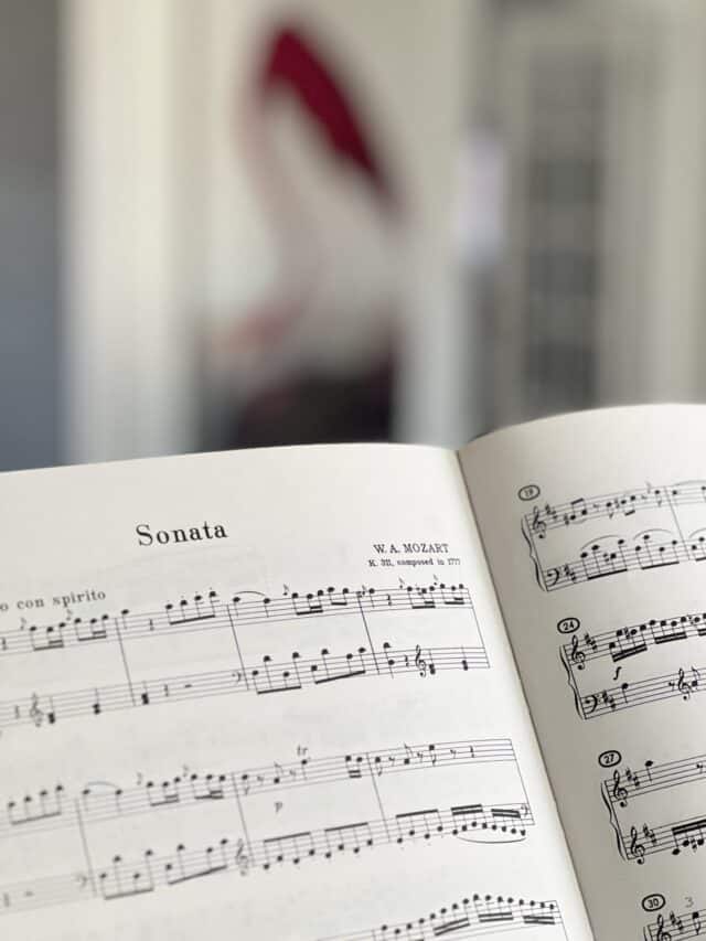 Piano music on a piano in a living room.