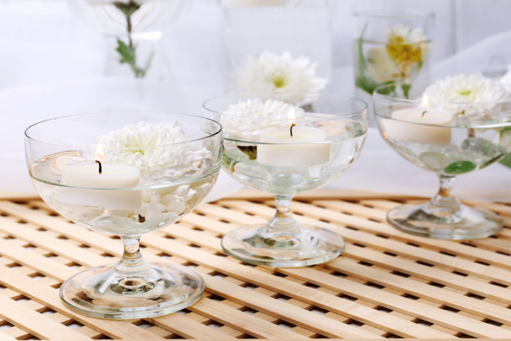 Floating candles in water on a table.