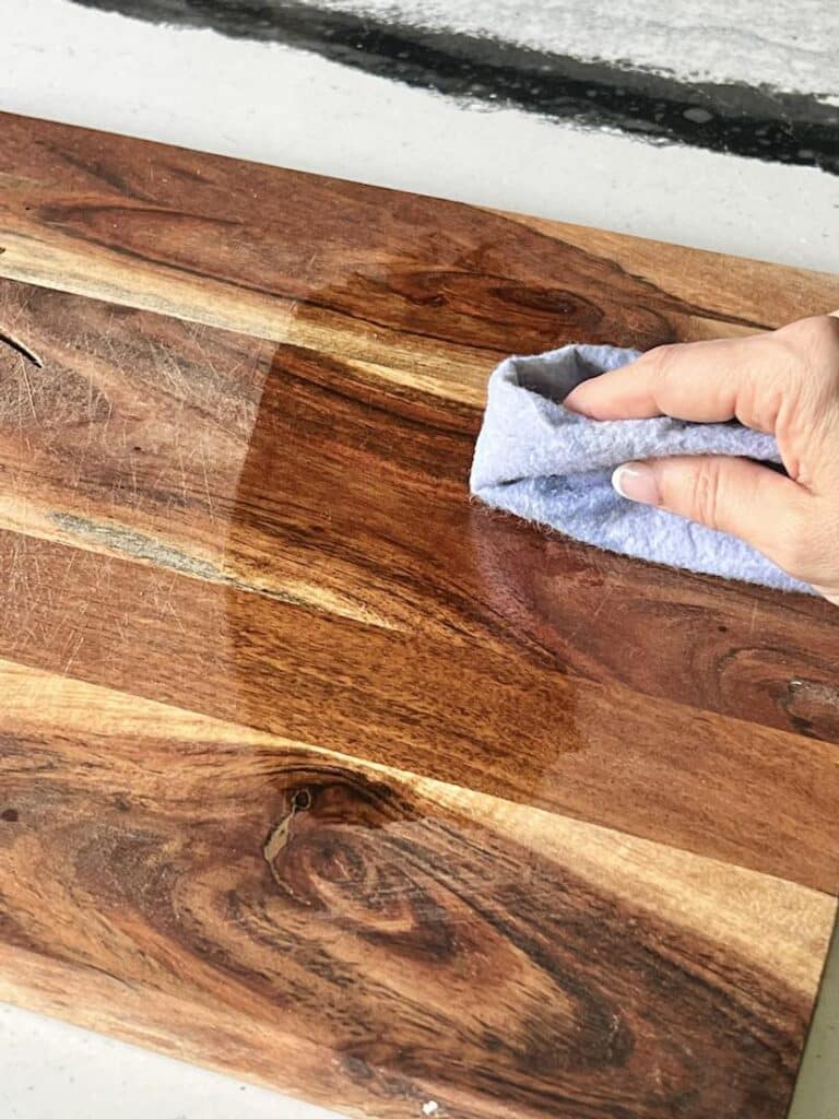 Oiling a wood cutting board with vegetable oil.
