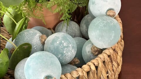 Jumbo glass bead garland styled in a rattan basket.