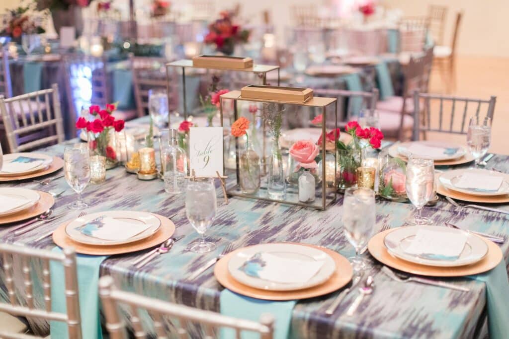 everyday table centerpiece ideas" Glass lanterns filled with bud vases and blooms on a wedding reception table.