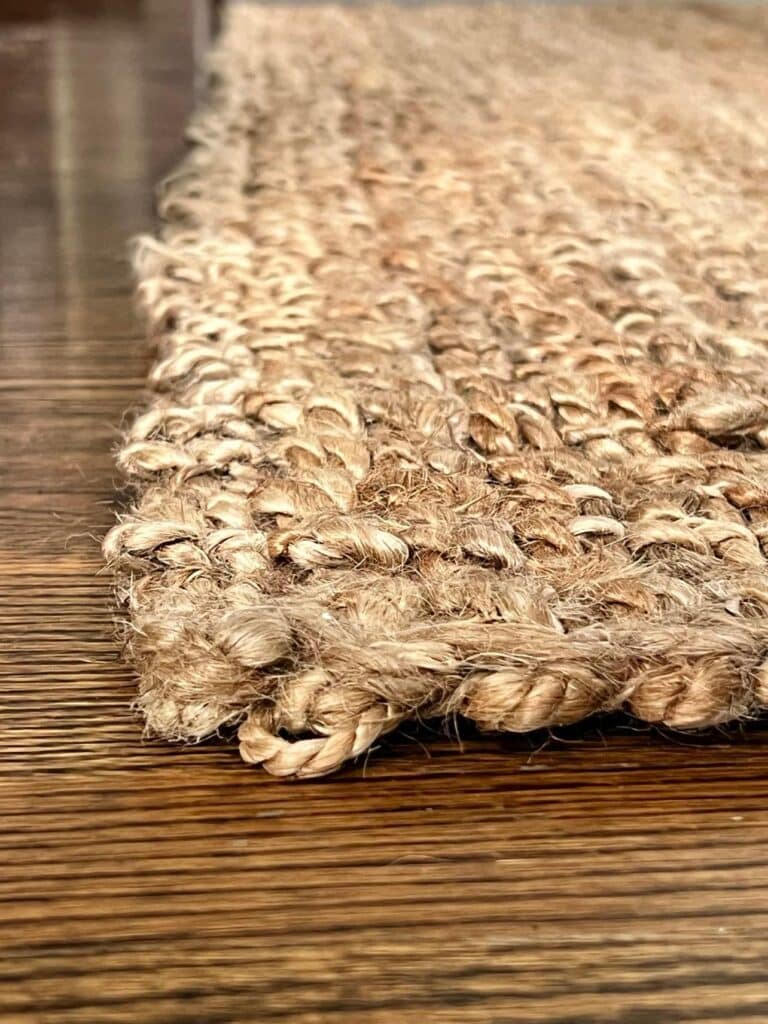 how to clean a jute rug: a close up view of the woven fibers of a jute rug.