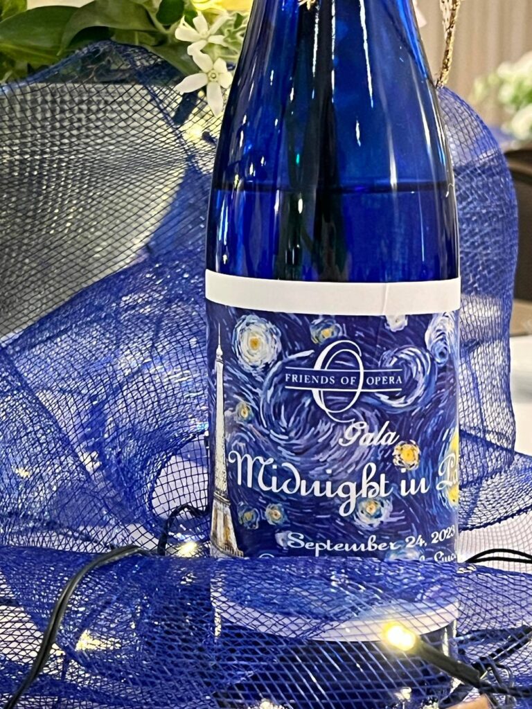A wine bottle with a gala label.